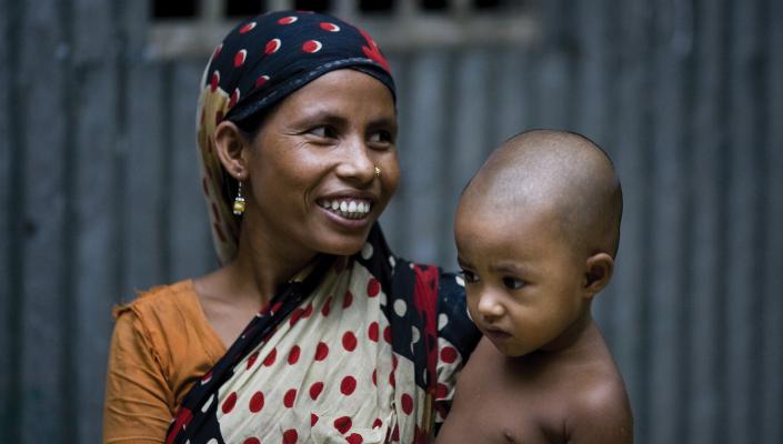 A woman in a scarf hold her child