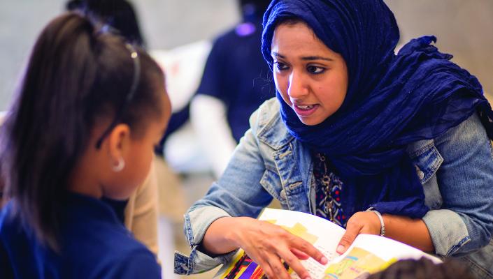 MPH student Mahendra Naidoo talks to an elementary student