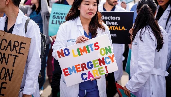 A group of doctors join abortion rights supporters at a rally outside the Supreme Court on April 24, 2024 in Washington, D.C. 