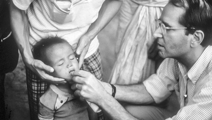 Al Sommer gives a child vitamin A drops