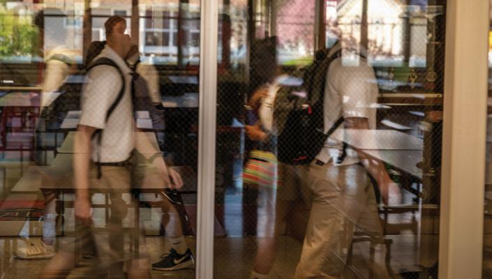 student walking past window