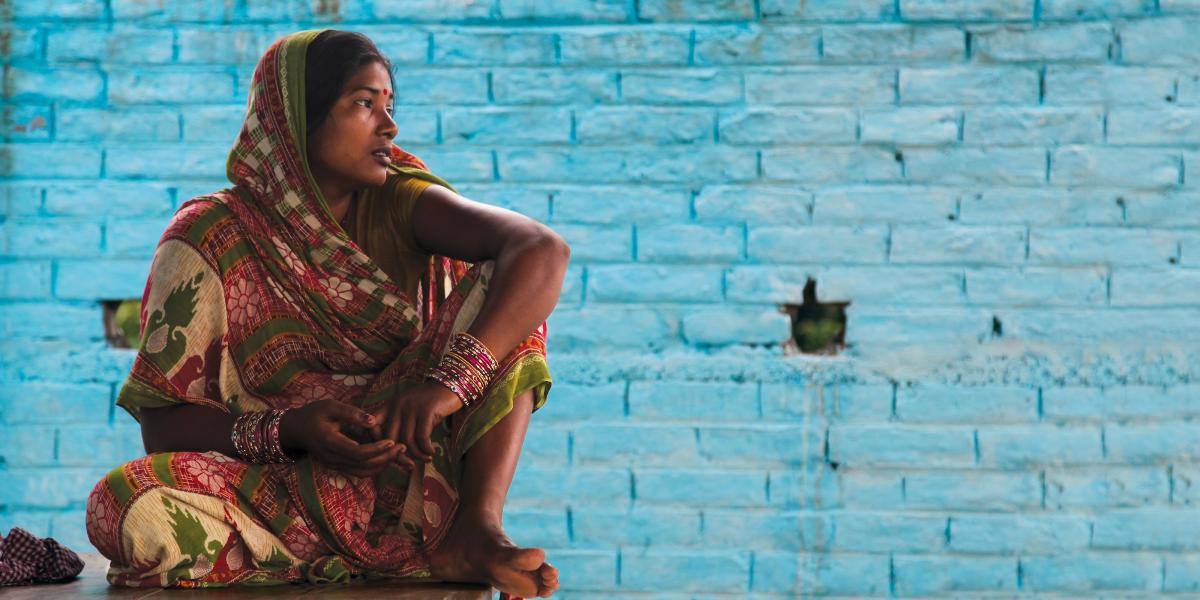 Sunita Kumari sits outside a community toilet facility