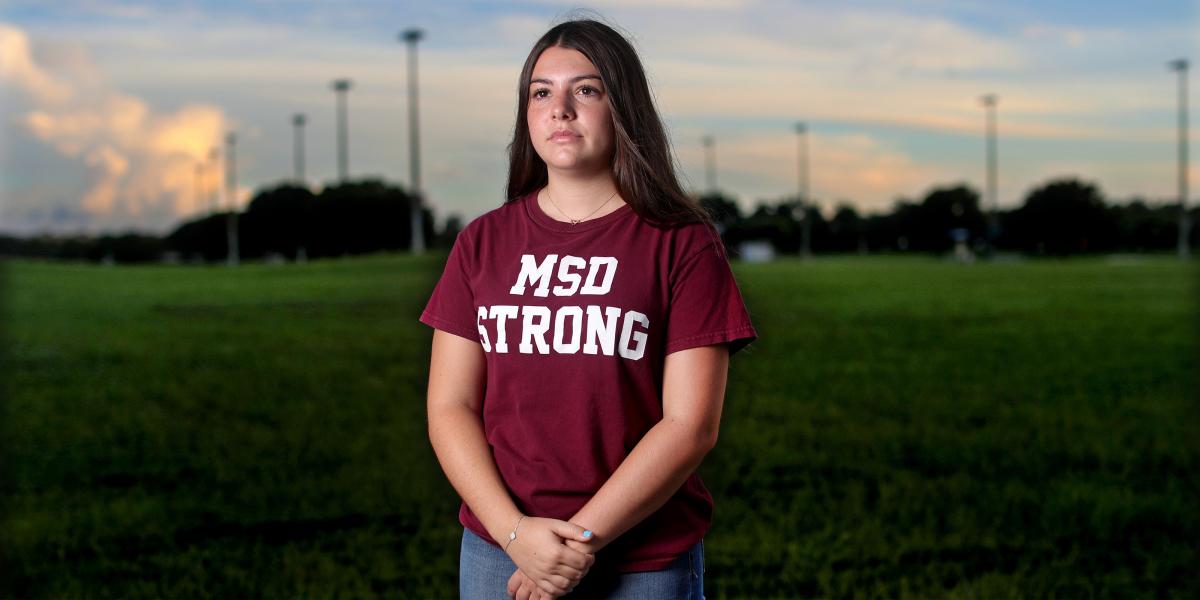 Wearing a shirt that says "MSD Strong," Sari Kaufman stands on the empty football field at Marjorie Stoneman Douglass High School in Parkland, Florida.