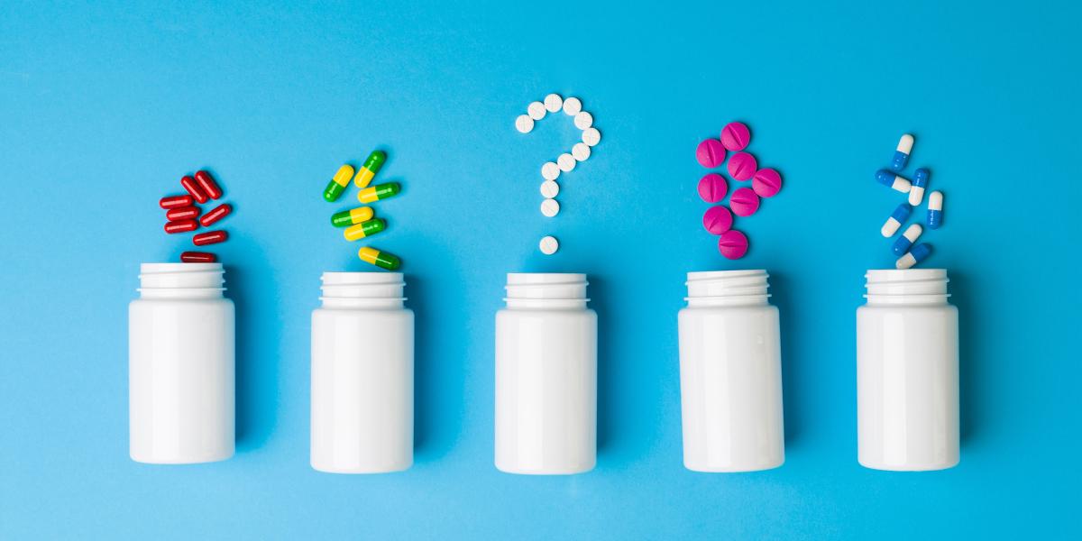  Prescription bottles and pills forming a question mark