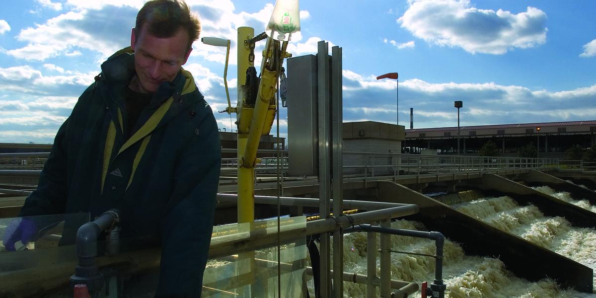 Rolf Halden takes a water sample at a treatment plant