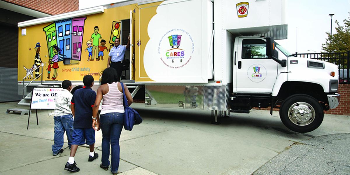 A family of 3 approaches the CARES van