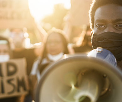 protesters with megaphone and end racism signs