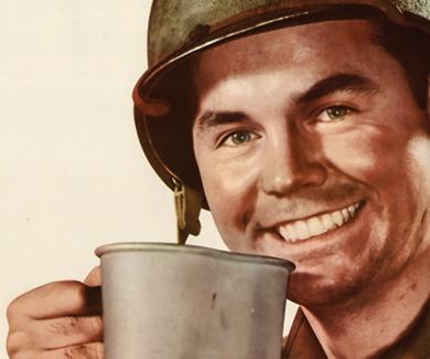 Smiling WWII GI drinking coffee